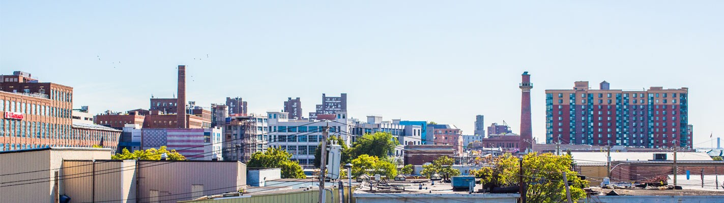 Person Holding a Pint and Looking Over Yonkers